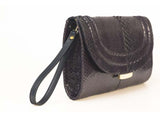 Aubergine python skin Jeeda clutch with gold-tone hardware, detachable leather wrist strap, and engraved designer plaque.
