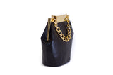 Black Valerie mini bucket bag in textured watersnake leather with gold-tone chain handle and designer logo clasp.