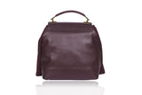 Bordeaux medium satchel in textured calf leather with a weaved flap, suede fringes, and elegant gold-tone hardware.