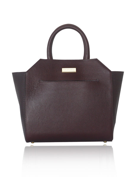 Bordeaux textured leather Sharon tote with raffia sides, gold-tone logo plaque, and elegant trapeze silhouette.