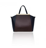 Sharon tote in smooth bordeaux and navy leather with elegant gold-plated hardware and a structured, spacious design.