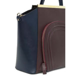 Bordeaux and navy smooth leather Sharon tote featuring a front zip pocket and elegant gold-plated hardware.