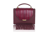 Bordeaux Steffany top handle bag in textured calf leather with a meshed water snake flap, suede fringes, and gold hardware.
