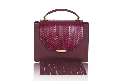 Bordeaux Steffany top handle bag in textured calf leather with a meshed water snake flap, suede fringes, and gold hardware.