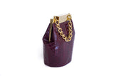 Bordeaux watersnake mini bucket bag featuring a luxurious gold-tone designer clasp and elegant chain handle.