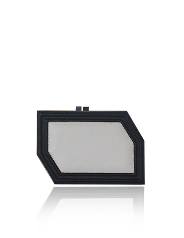 Geometric Edith clutch in textured black and off-white calf leather with a sleek, modern box silhouette and gunmetal hardware.