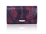Cherry red and black python skin clutch featuring gold-tone hardware and an engraved designer plaque on the front lock.