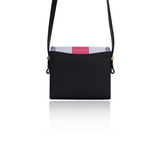 Anya crossbody bag in black calf leather with a cream flap, watermelon laser-cut trim, and elegant gold-tone hardware.