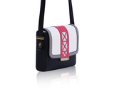 Anya crossbody bag in black calf leather with a cream flap, watermelon laser-cut trim, grey borders, and elegant gold hardware.