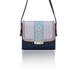 Cream and navy leather Anya crossbody bag with mint laser-cut trim, powder pink borders, and elegant silver-tone hardware.