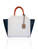 Cream and navy textured leather Sharon trapeze tote with papaya handles, nude hanging tag, and silver-tone hardware.