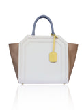 Structured cream and sand textured leather Sharon tote with teal blue handles, banana yellow tag, and gold-tone hardware.