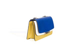 Mini Jackie O shoulder bag in mustard calf leather, electric blue lizard flap, and cream compartment with silver hardware.