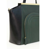 Emerald green and black smooth leather trapeze tote with gold plaque and front zip pocket.