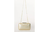 Lustrous gold textured leather Gina clutch with pointed studs, gold-tone hardware, and a chic chain shoulder strap.