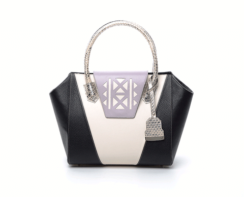 Ashley tote in black and cream textured leather with a lilac laser-cut front, python-effect handle, and silver logo.