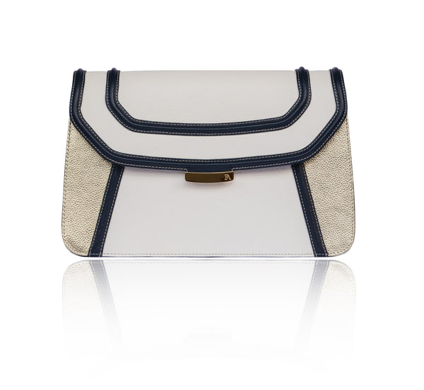 Navy and cream textured leather clutch with gold accents, magnetic clasp, and elegant designer plaque.