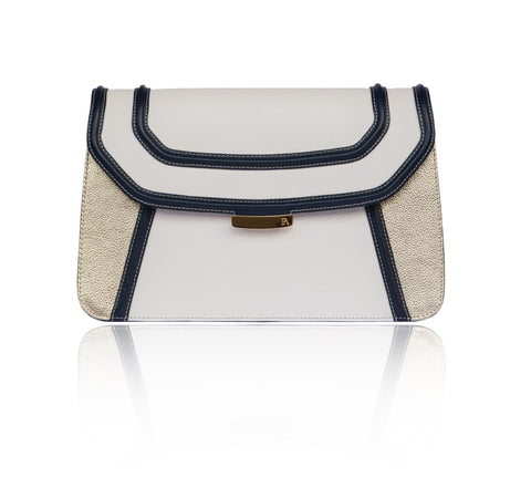 Navy and cream textured leather clutch with gold accents, magnetic clasp, and elegant designer plaque.