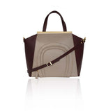 Oversized nude and burgundy textured leather tote with gold-plated plaque, top handles, and detachable shoulder strap.