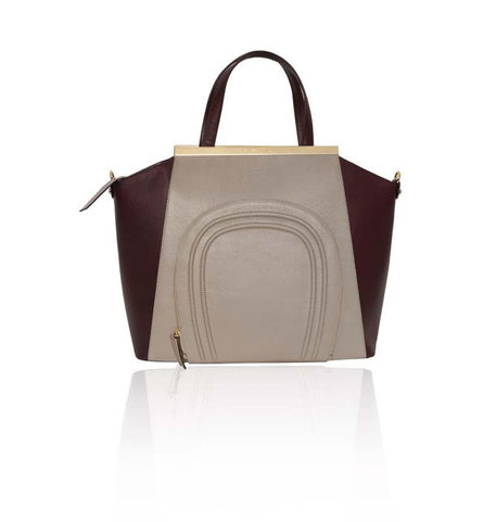 Oversized nude and burgundy textured leather Sharon tote with gold-plated plaque, top handles, and front pocket detail.