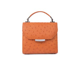 Papaya orange mini Steffany tote in textured ostrich leather with a silver designer logo plaque and top handle.