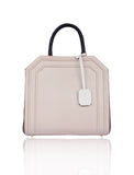 Powder pink and taupe textured leather Sharon tote with black top handles, cream hanging tag, and gold-tone hardware.