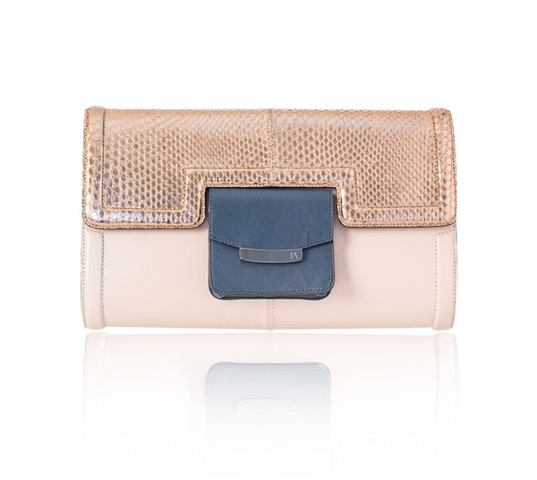 Serena clutch in powder pink lamb leather with a rose gold python flap, storm blue pocket, and gunmetal logo plaque.
