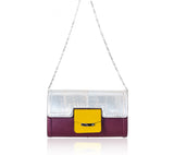 Serena clutch in plum leather with a silver python flap, mustard pocket, and detachable silver chain strap.