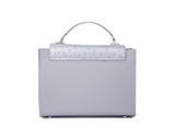 Silver gray Steffany tote in textured ostrich skin with a sleek top handle and elegant silver-tone hardware accents.