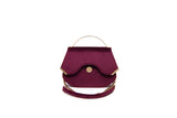 Wine red velvet Calypso top-handle bag with gold-tone hardware, designer logo, and detachable chain strap.